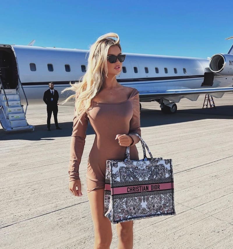 Sexye blonde next to private jet