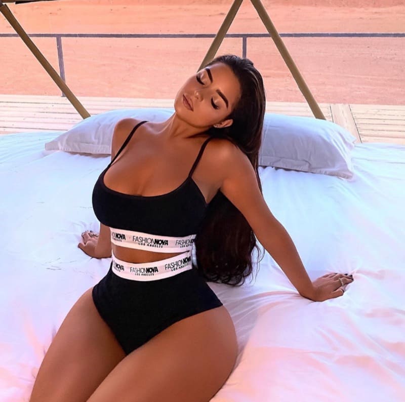 Demi in sexy outfit on bed