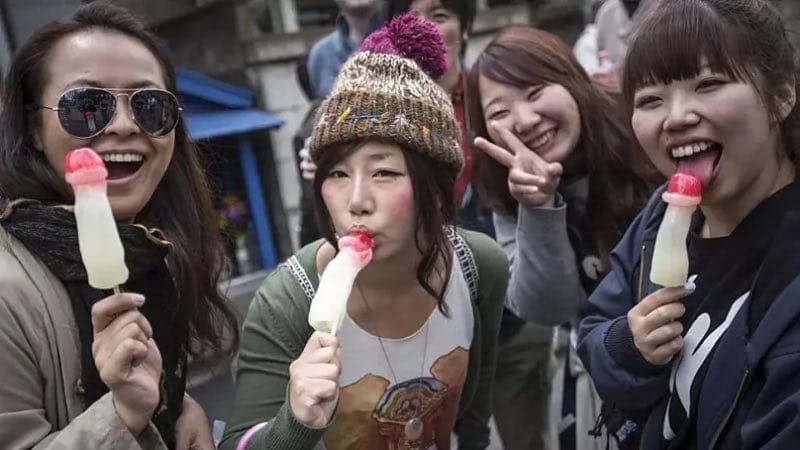 People eating penis shaped candy 