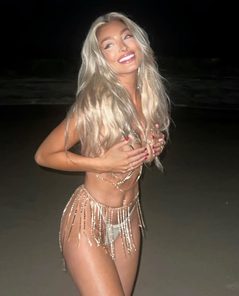 Blonde babe on beach covering nude boobs