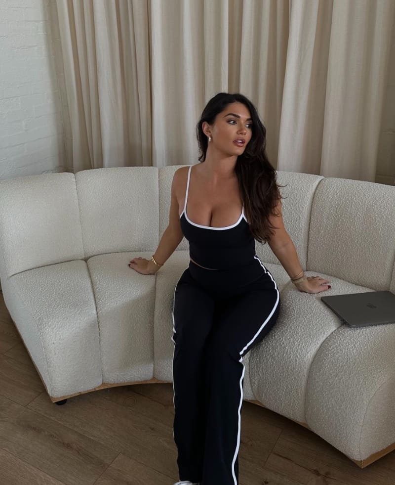 India on sofa in black dress