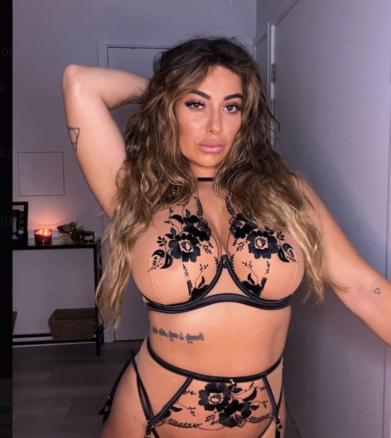 Babe with brown curls and massive tits in lingerie