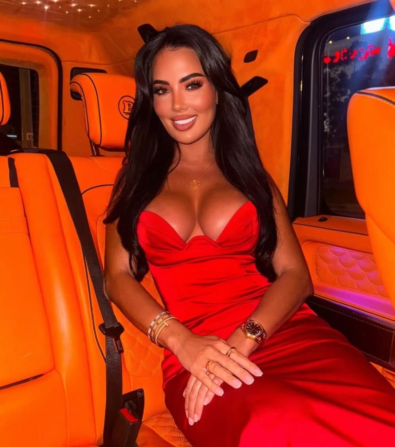 Yazmin in red dress in orange interior car