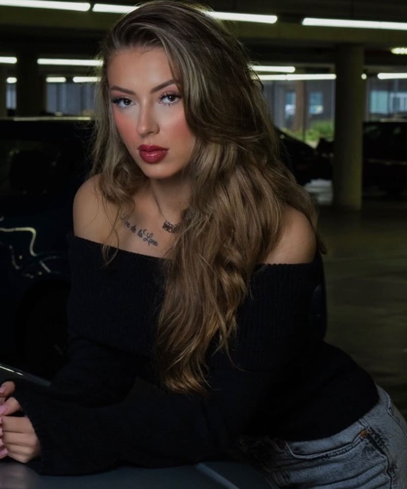Sexy brunette in car park