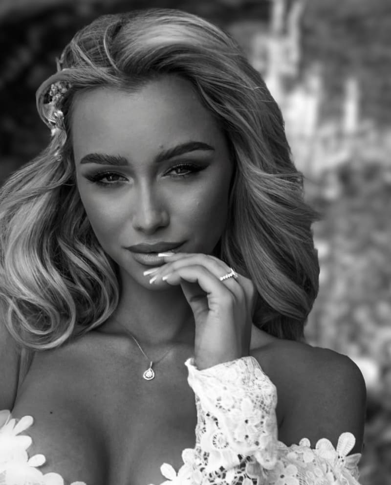 Eszter in close up while wearing white dress