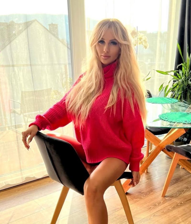 Ewelina in red sweater on chair