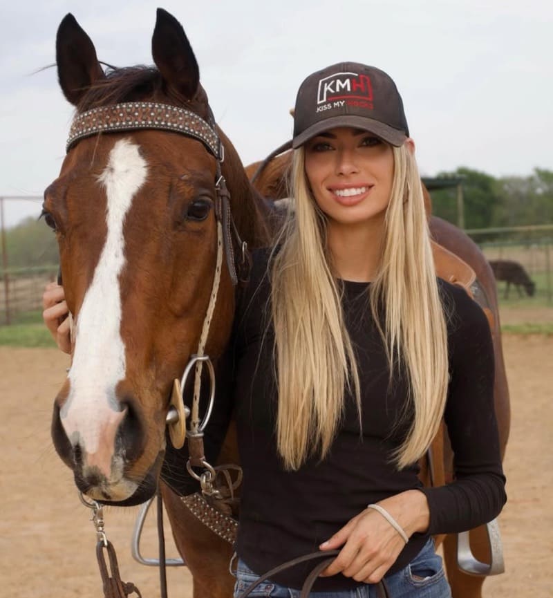 Blonde babe next to horse