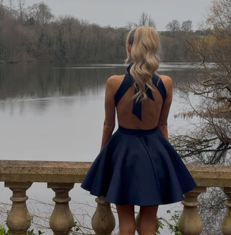 Sexy blonde woman in short blue dress
