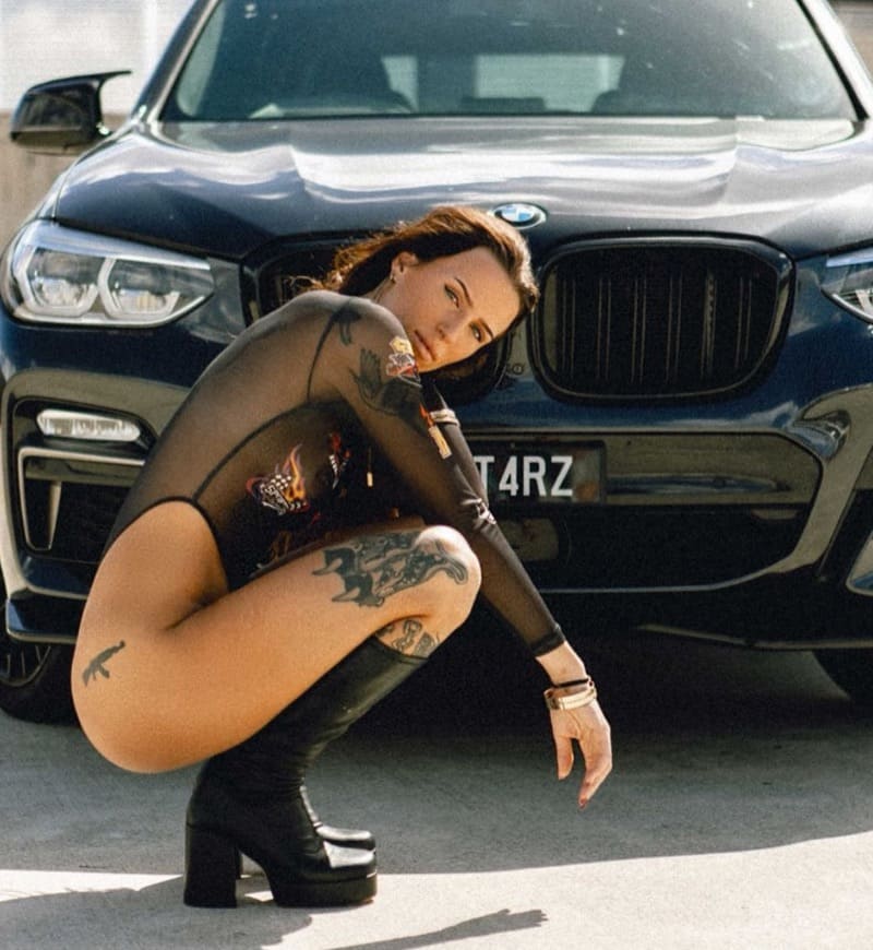 Babe in front of car