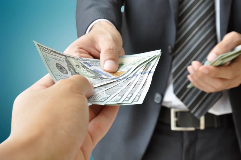 Person giving money for illigal activities wildlife