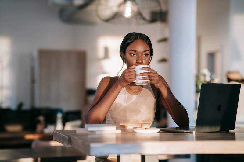 Woman Drinking coffee in house