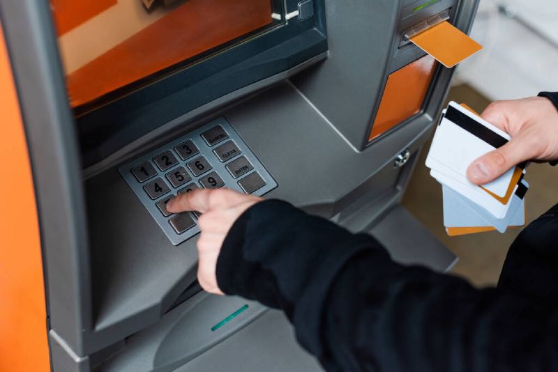 Person using PIN at ATM