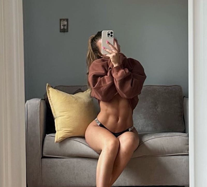 Sexy dame met sixpack in lingerie op zetel
