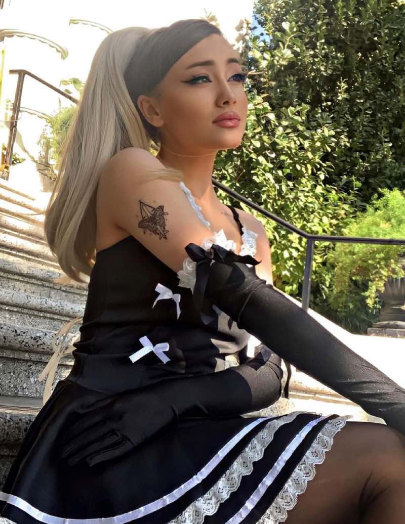 Paige in maid outfit outside