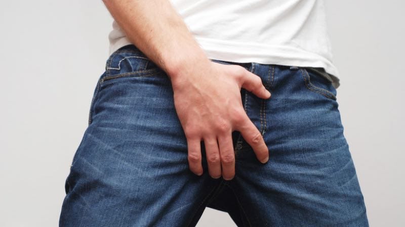 Man grabbing pants