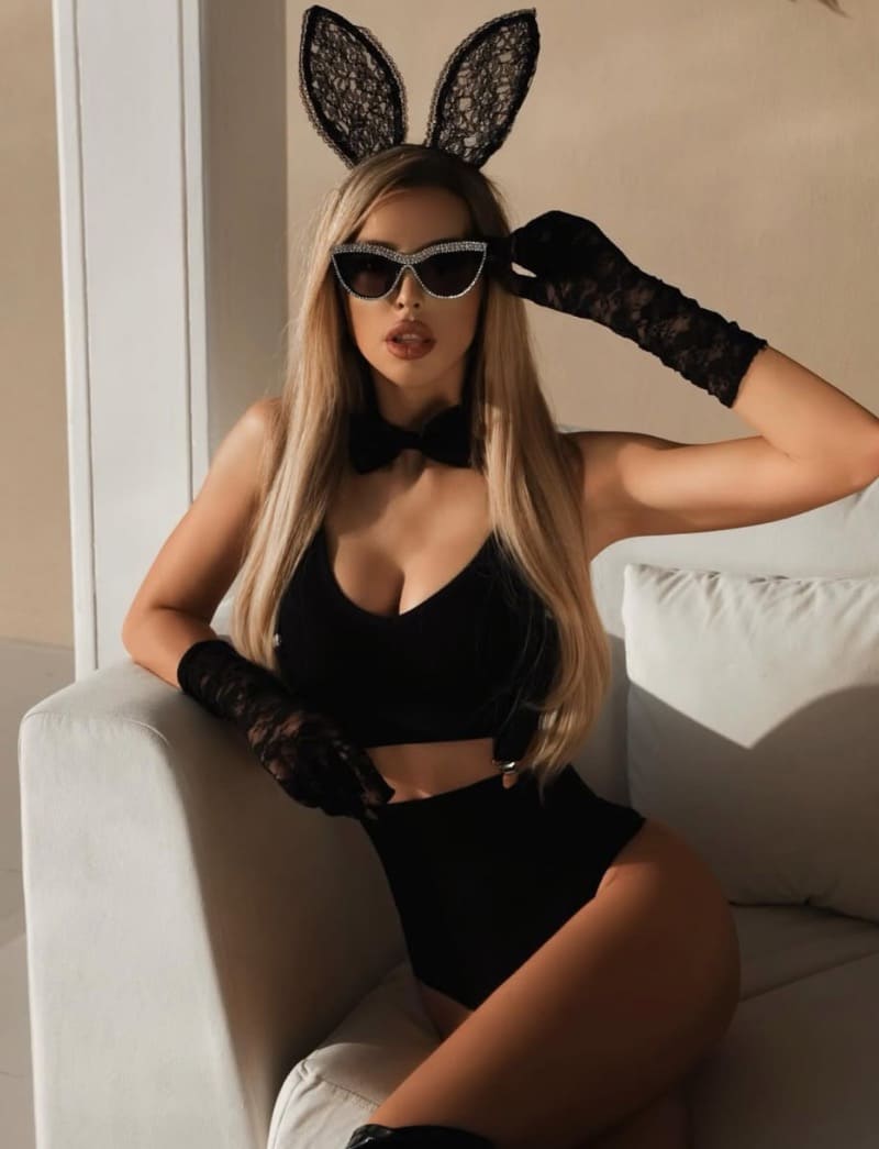 Edina in bunny outfit on couch