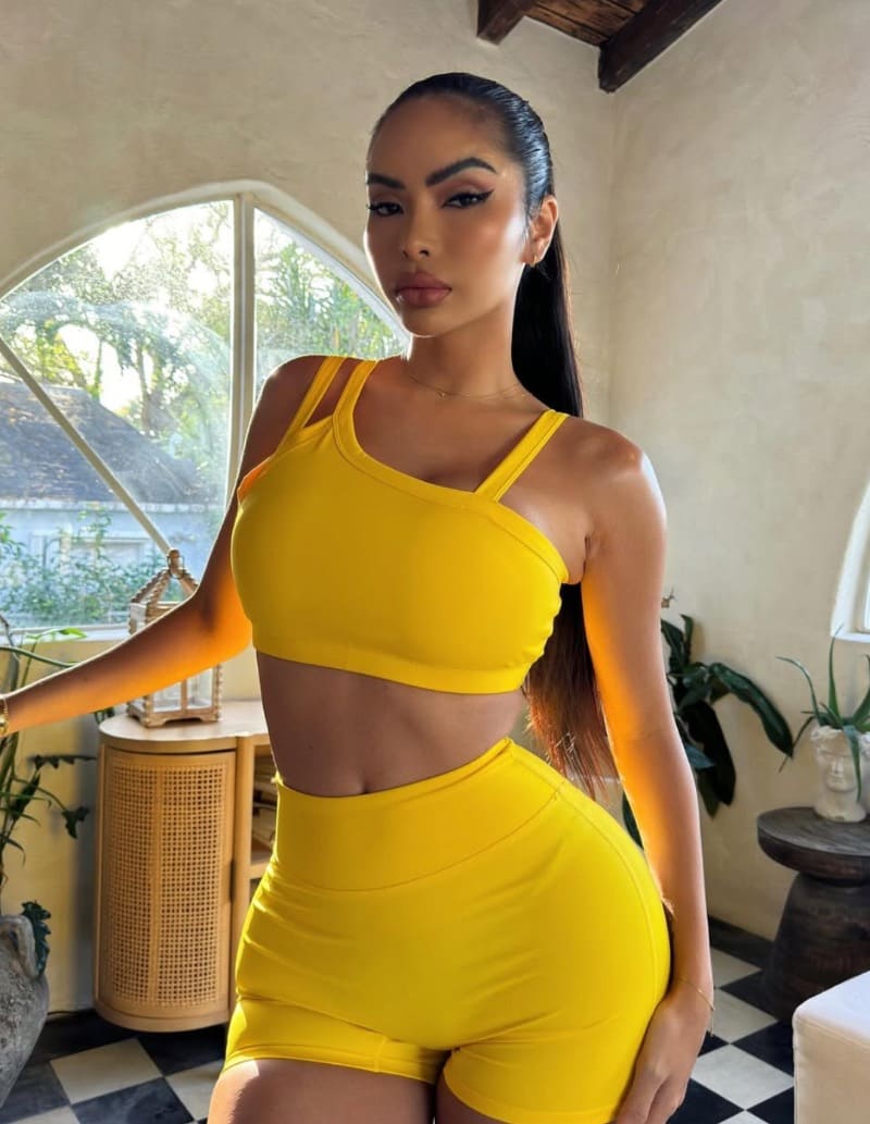 Sexy brunette in yellow sport outfit