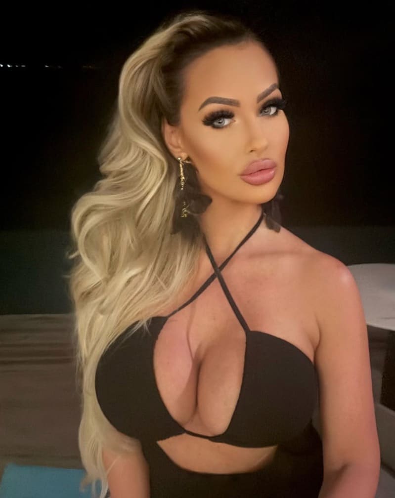 Anna shows off massive boobs in dark dress