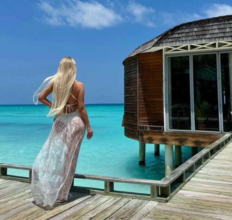 Babe in white beach dress next to water