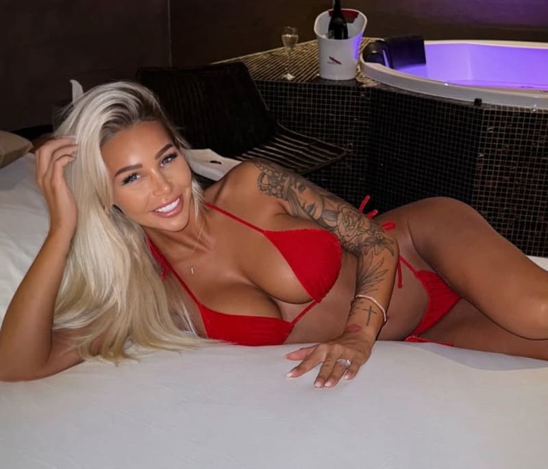 Babe in red bikini on bed