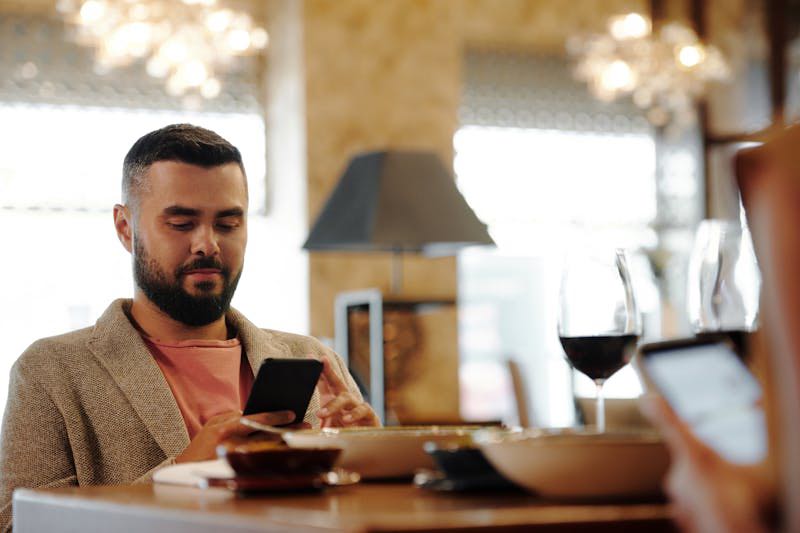 Man texting in restaurant
