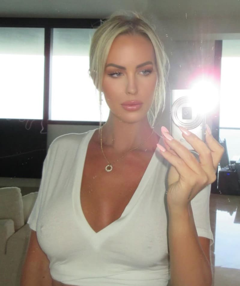 Sexy blonde taking selfie in tight top