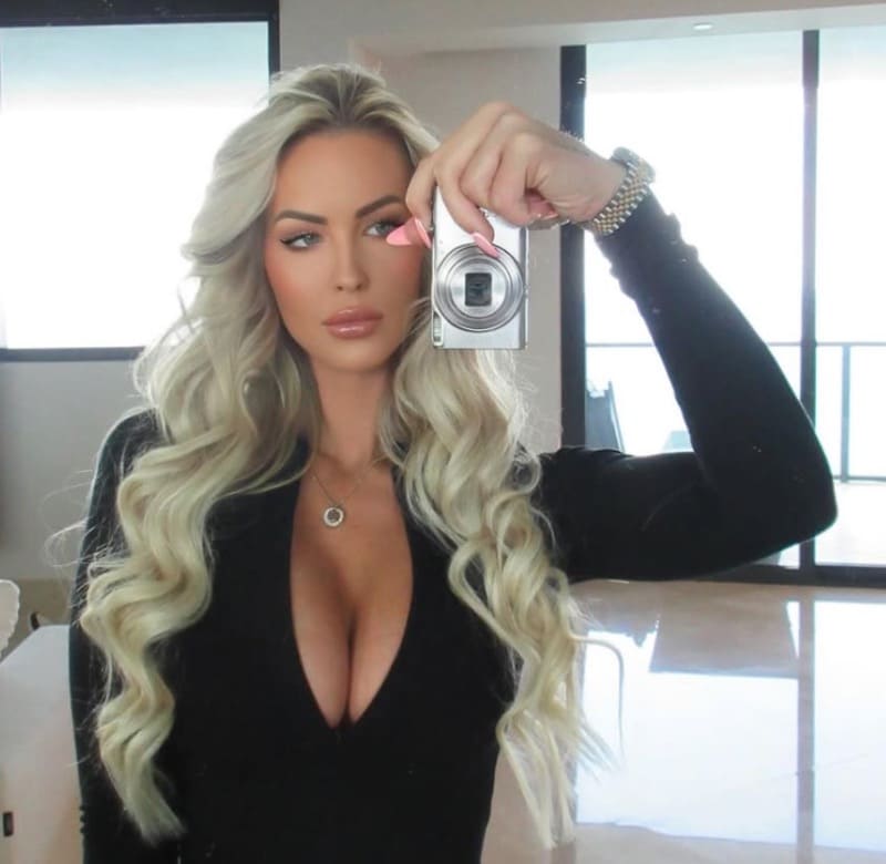 Blonde babe with big tits in tight black outfit