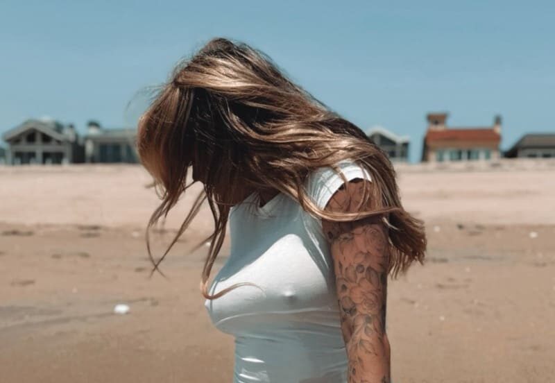 Sexy woman on beach in bikini and tight top