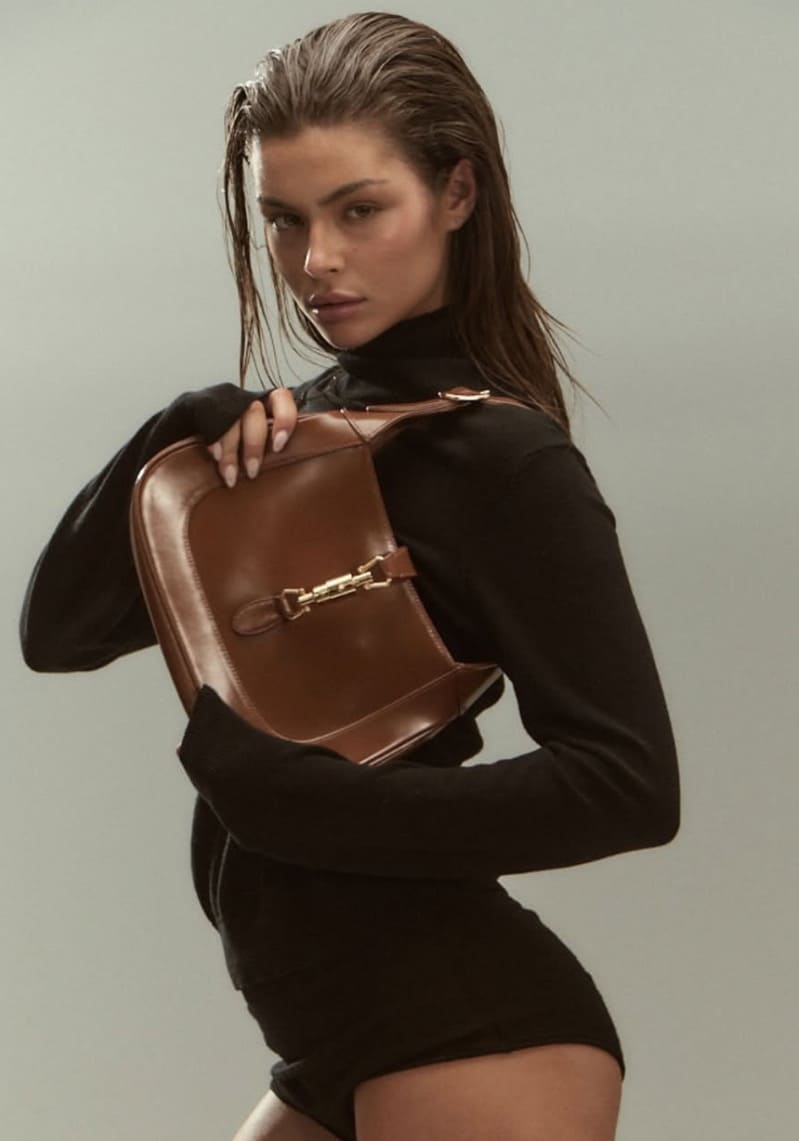 Olivia in sexy black outfit with purse