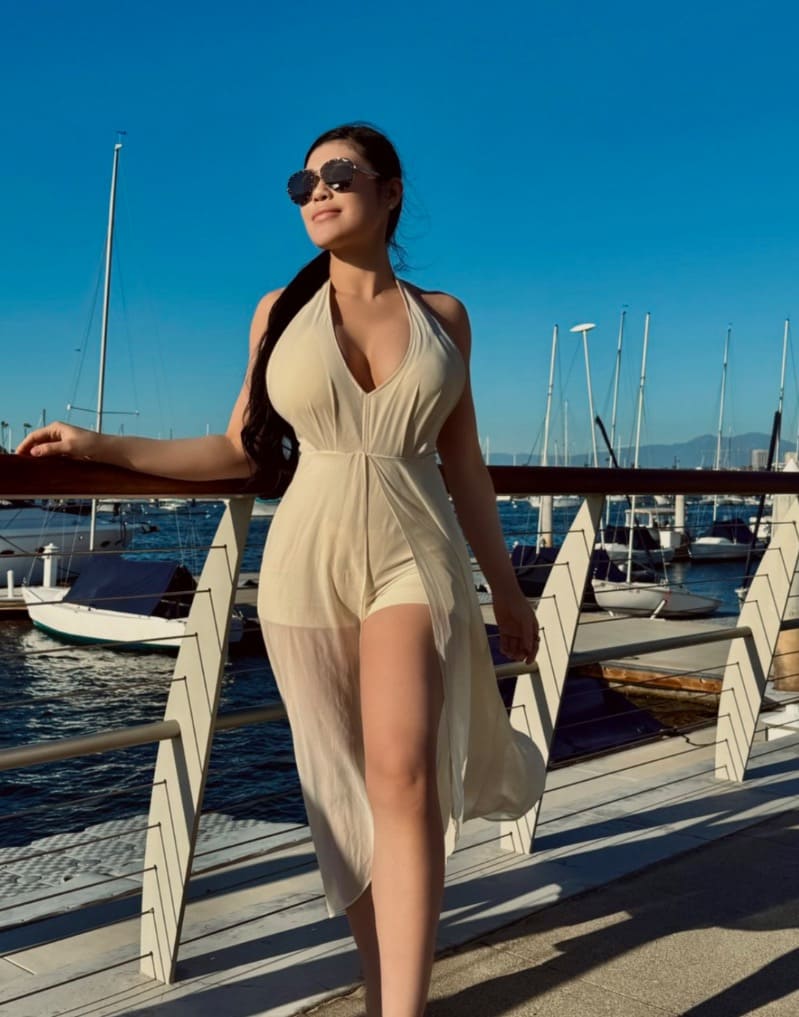 Babe next to boats in sexy dress