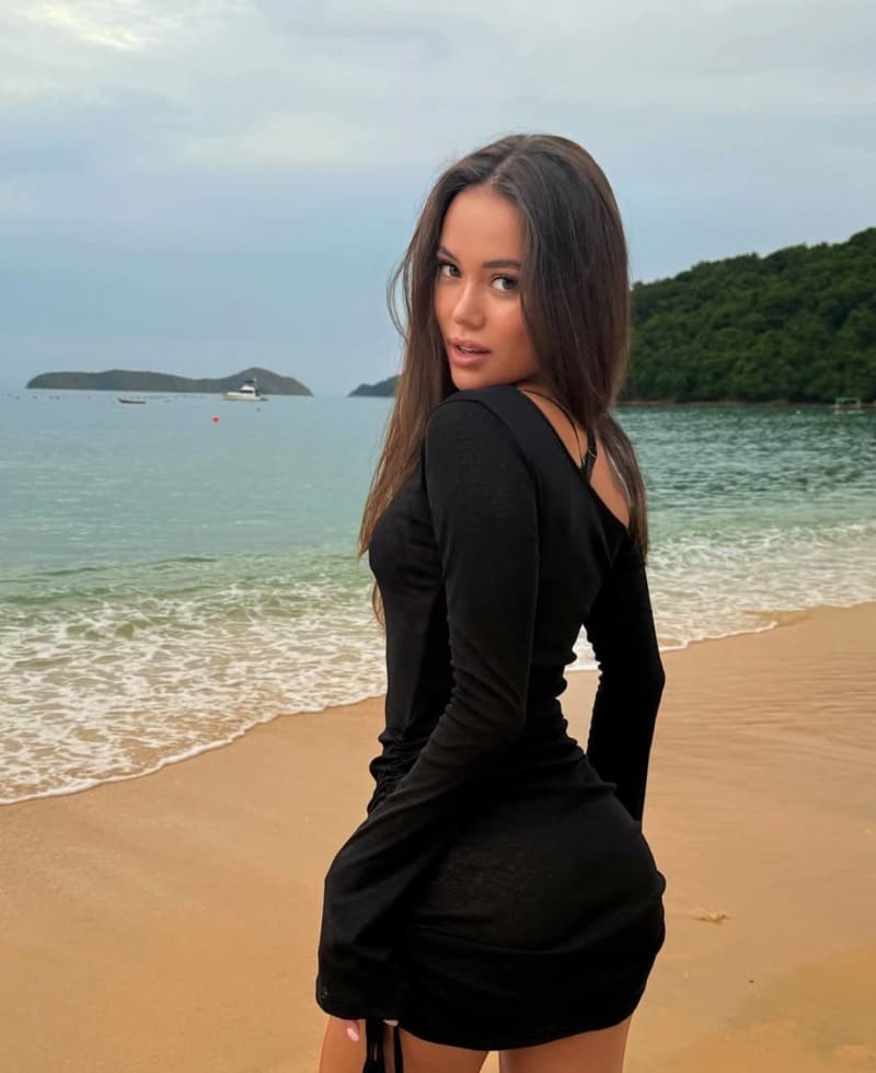 Anna in black dress on beach