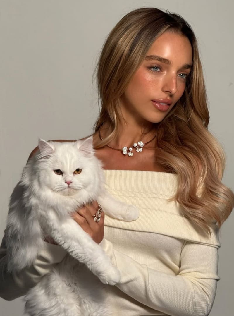 Shelby holding cat in white top