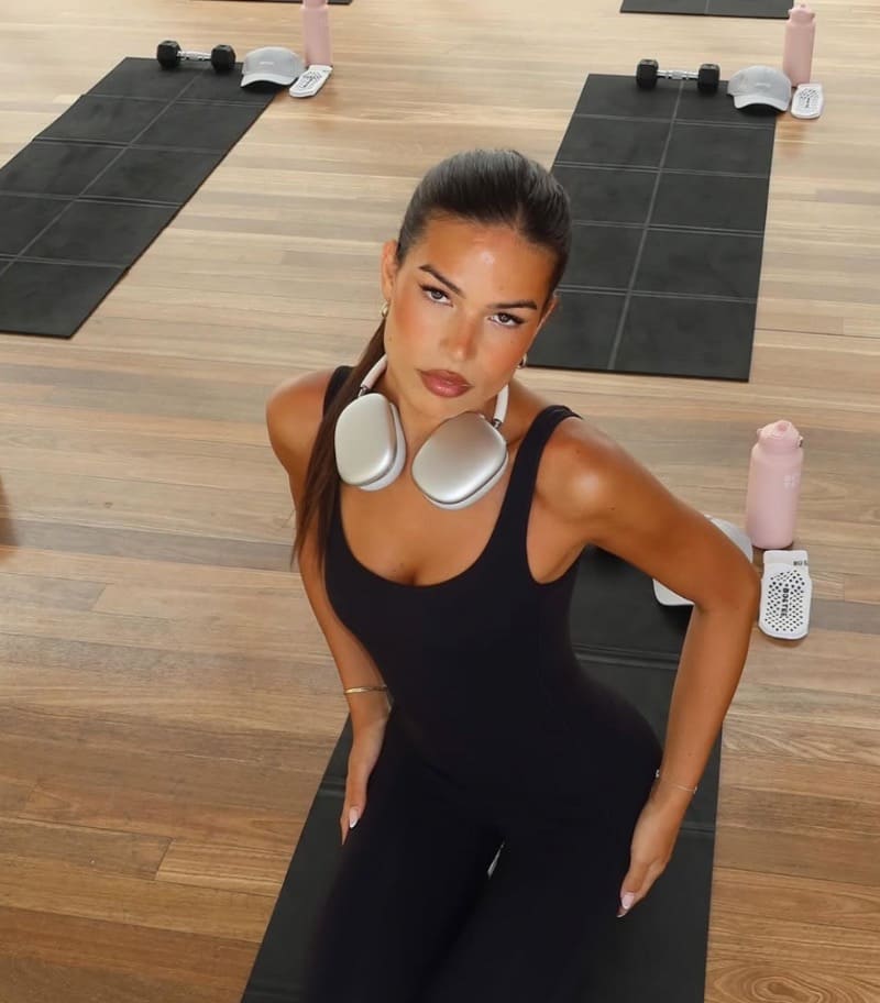 Sexy model in black sports clothes with apple Airpod Max