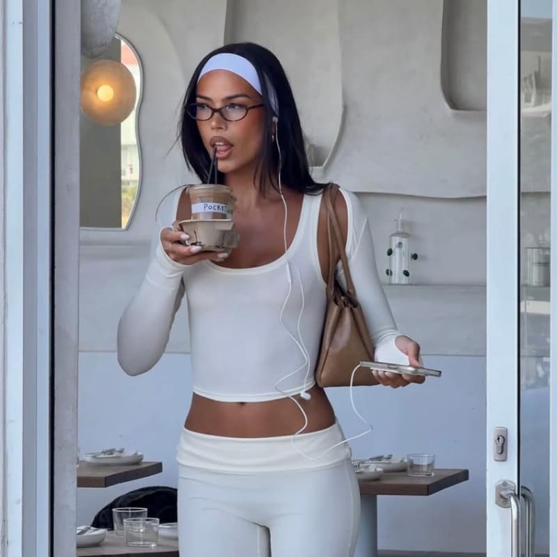 Riley in white sports outfit