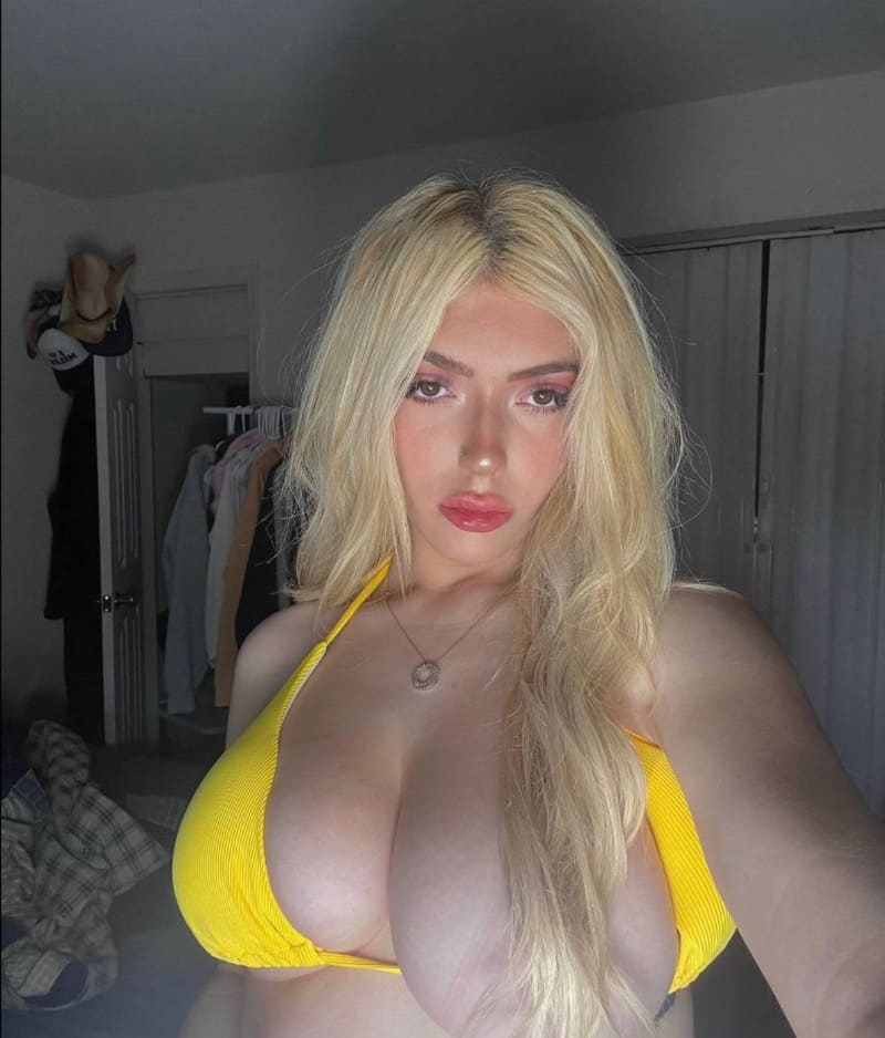 Hot blonde takes selfie with one boob out of bikini