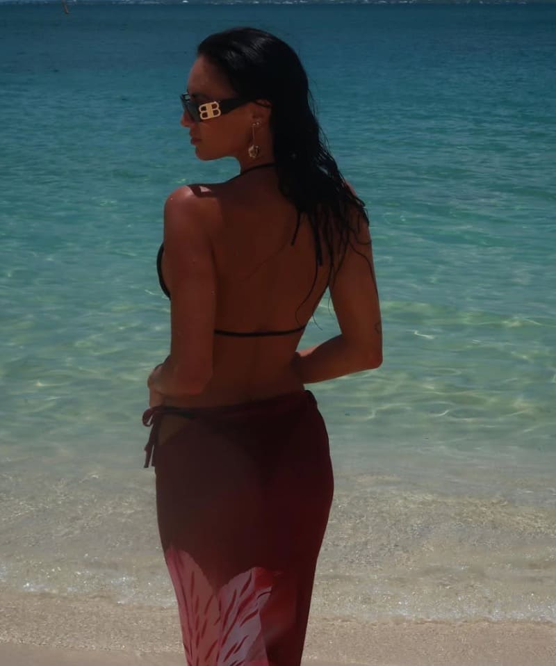 Kylie on beach with nice skirt