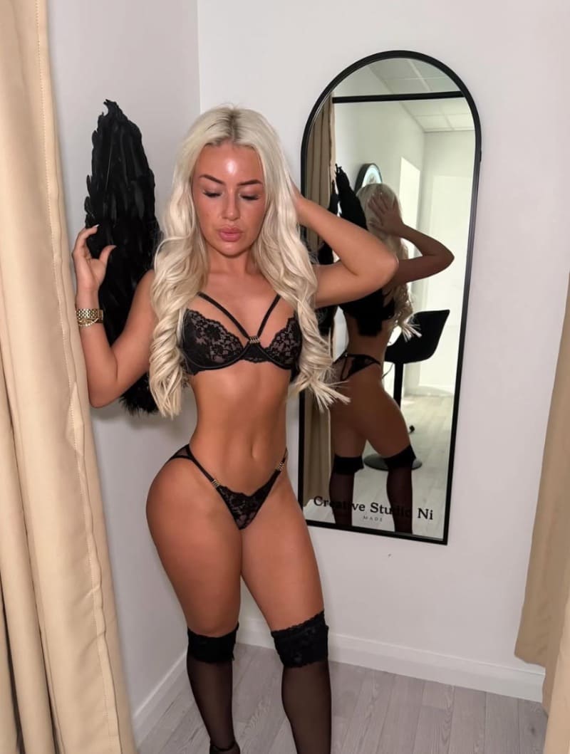 Hot blonde standing in black lingerie