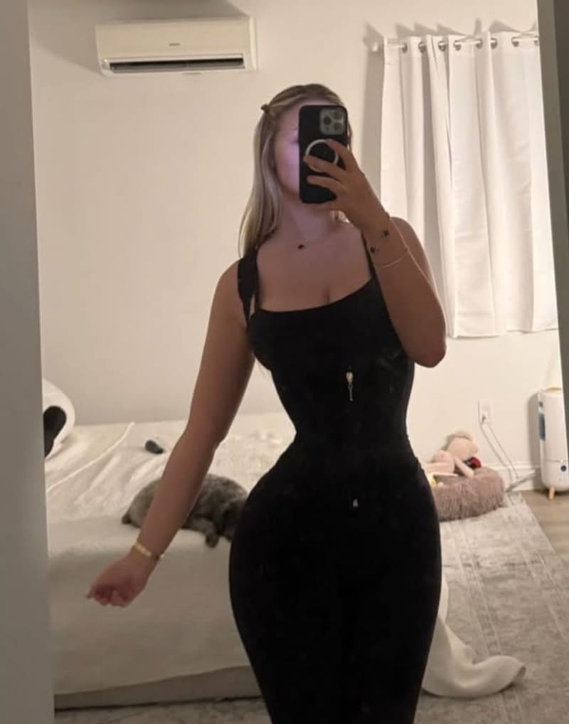 Tana in tight black dress