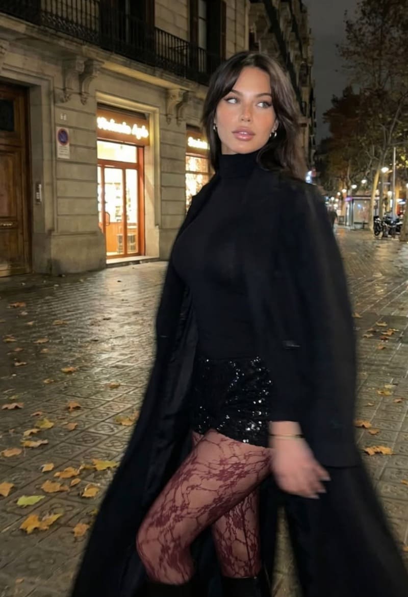 Sexy model in black long jacket