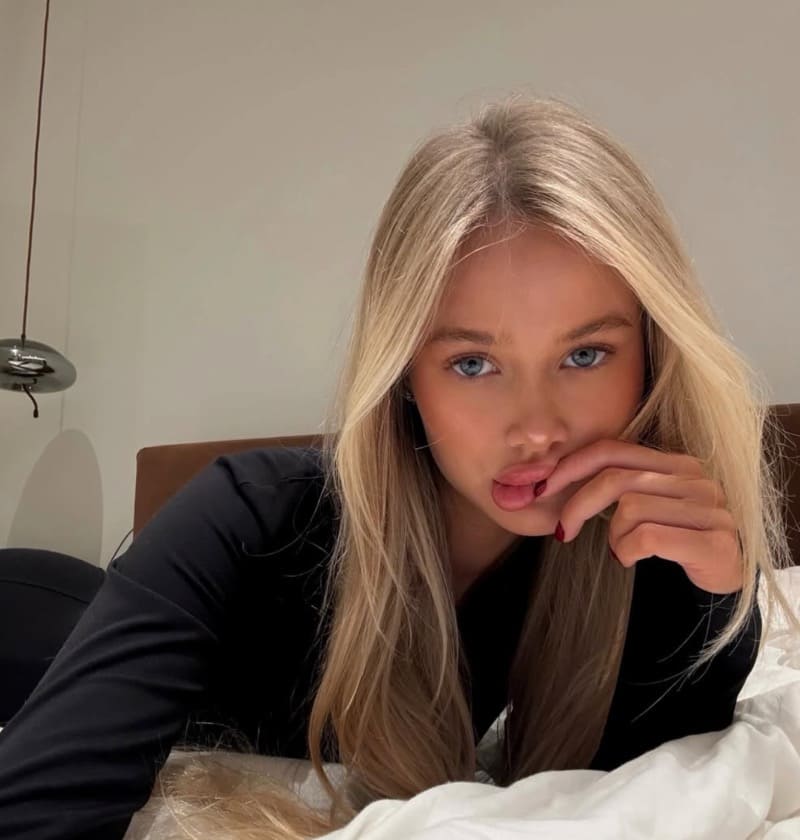 Sonya on bed in tight dress