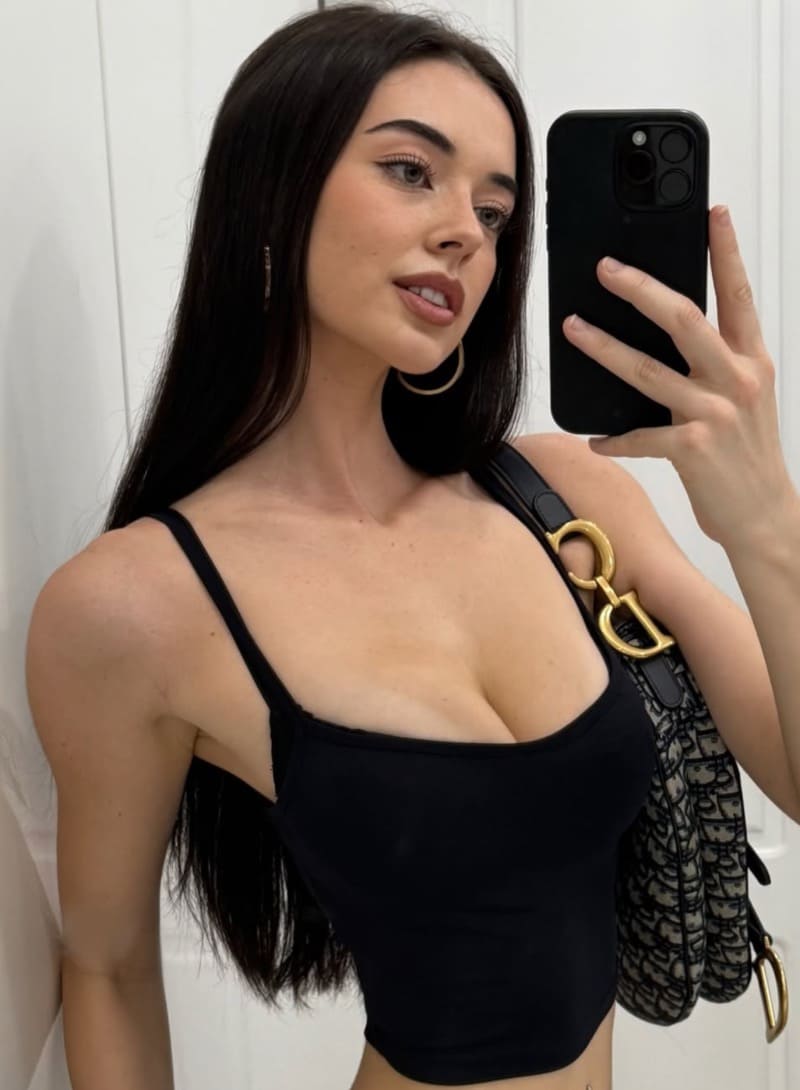 Sexy brunette with big boobs taking selfie