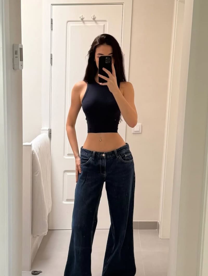 Chanel in tight top and lowrise jeans