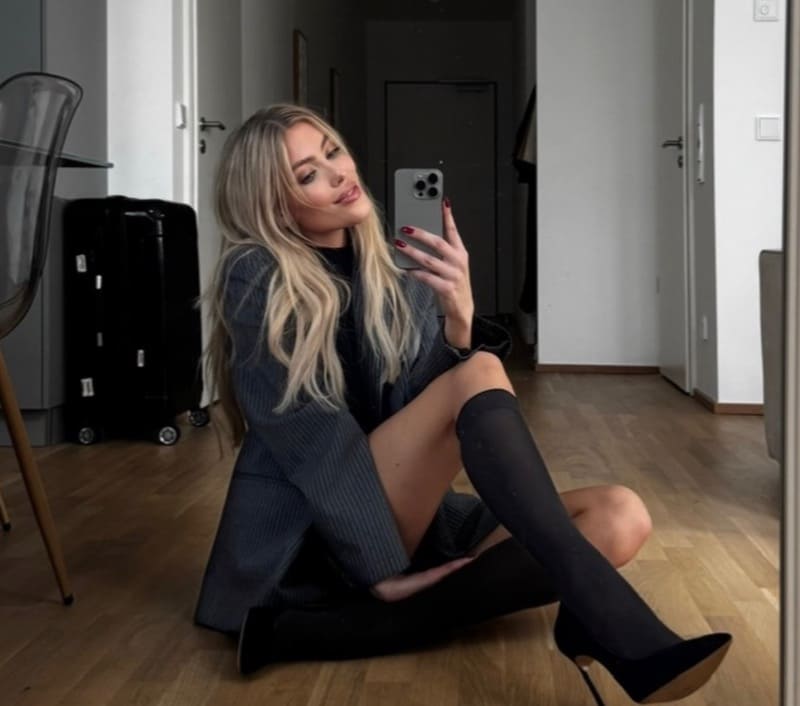 Fee in sexy outfit taking mirror selfie