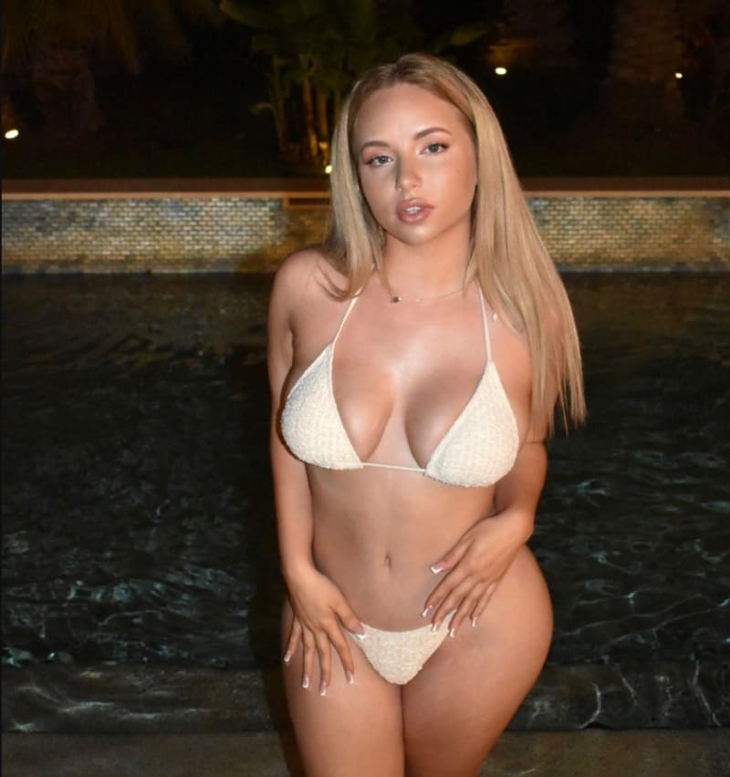 Blonde babe with big boobs in white bikini