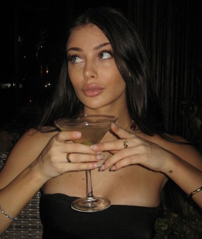 Milaydie with a drink and shoulderless dress