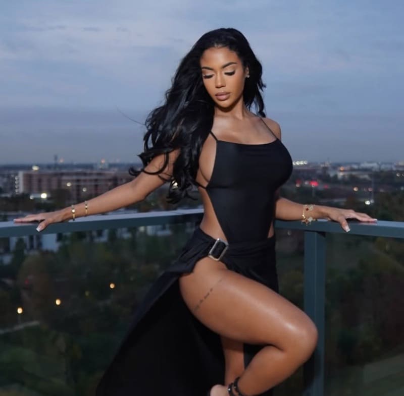 Aliyah in black outfit on rooftop