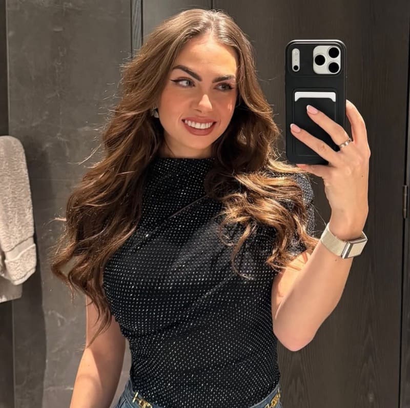 Sexy babe in black top taking mirror selfie