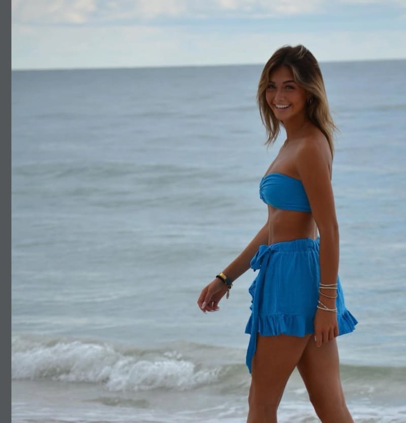 Ava on beach in blue outfit