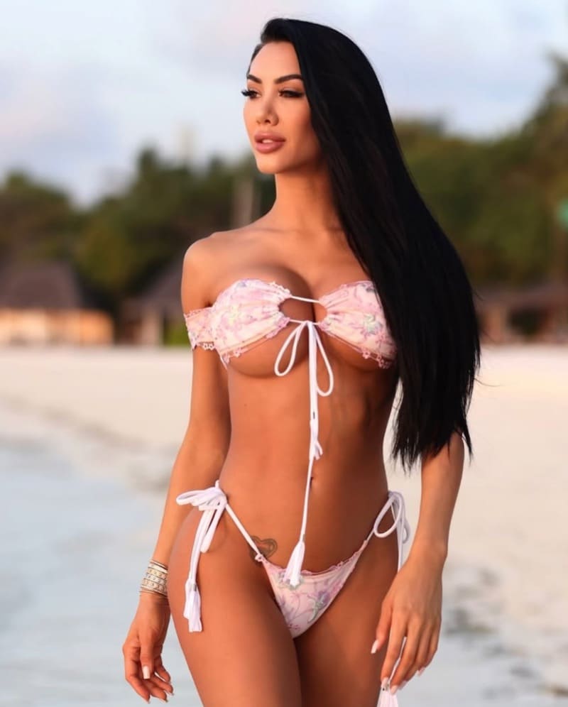 Sexy model with big tits in white bikini