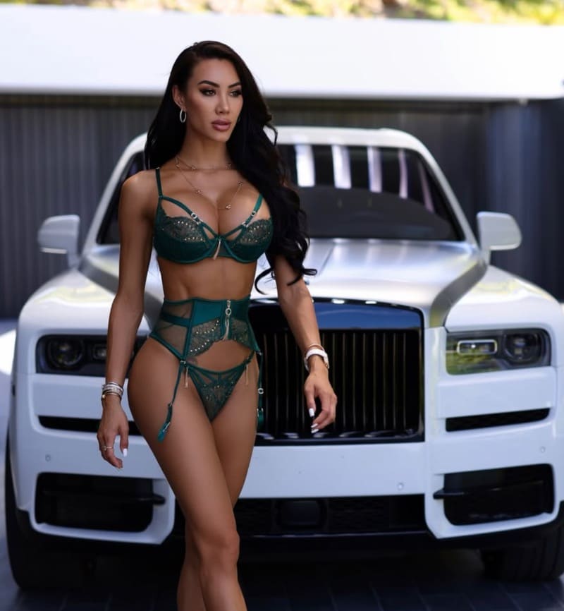 Babe in green lingerie in front of luxury car
